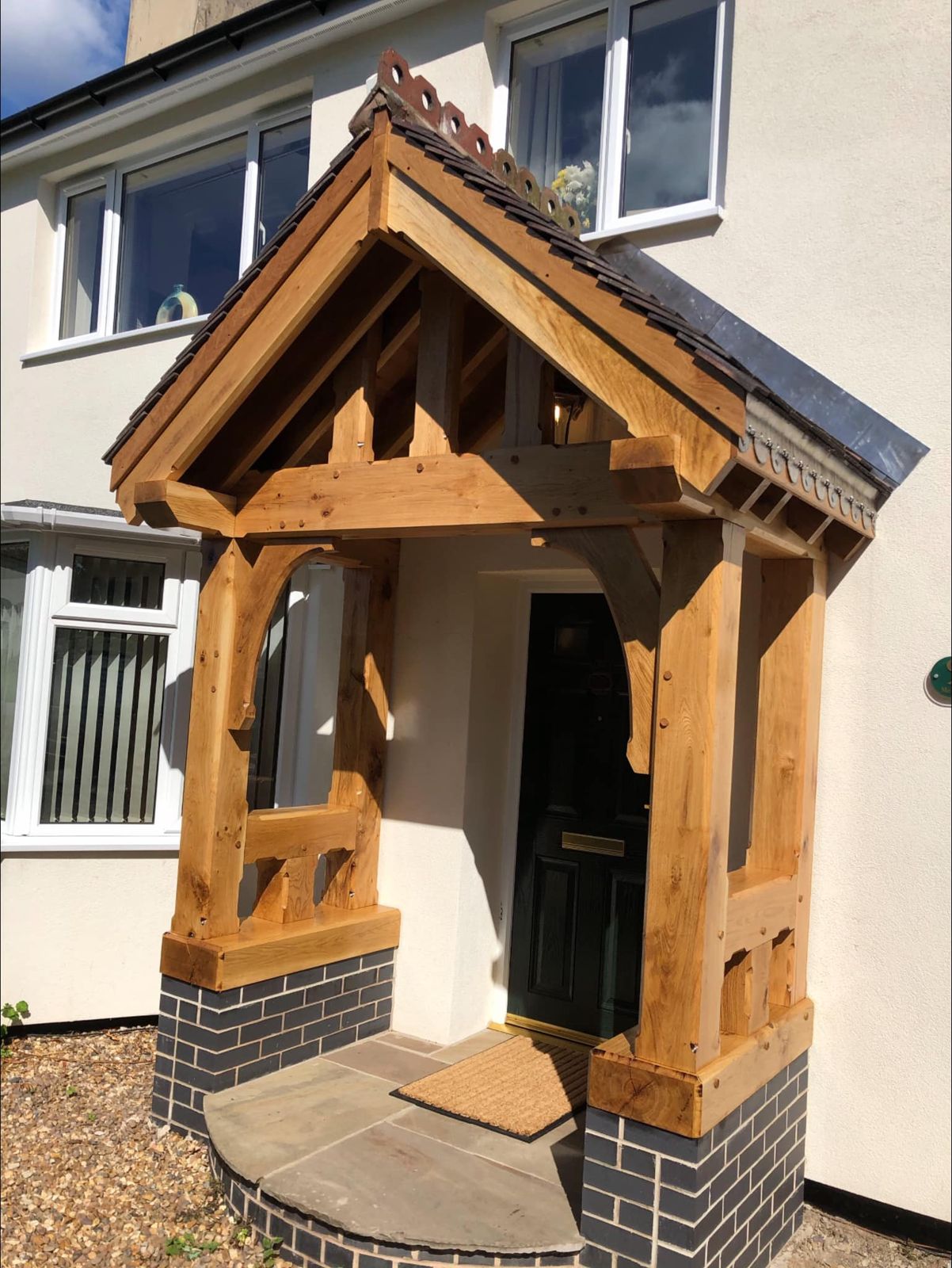 Oak porch on a rendered house